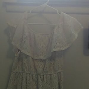 Off the shoulder cream dress with lace on top.